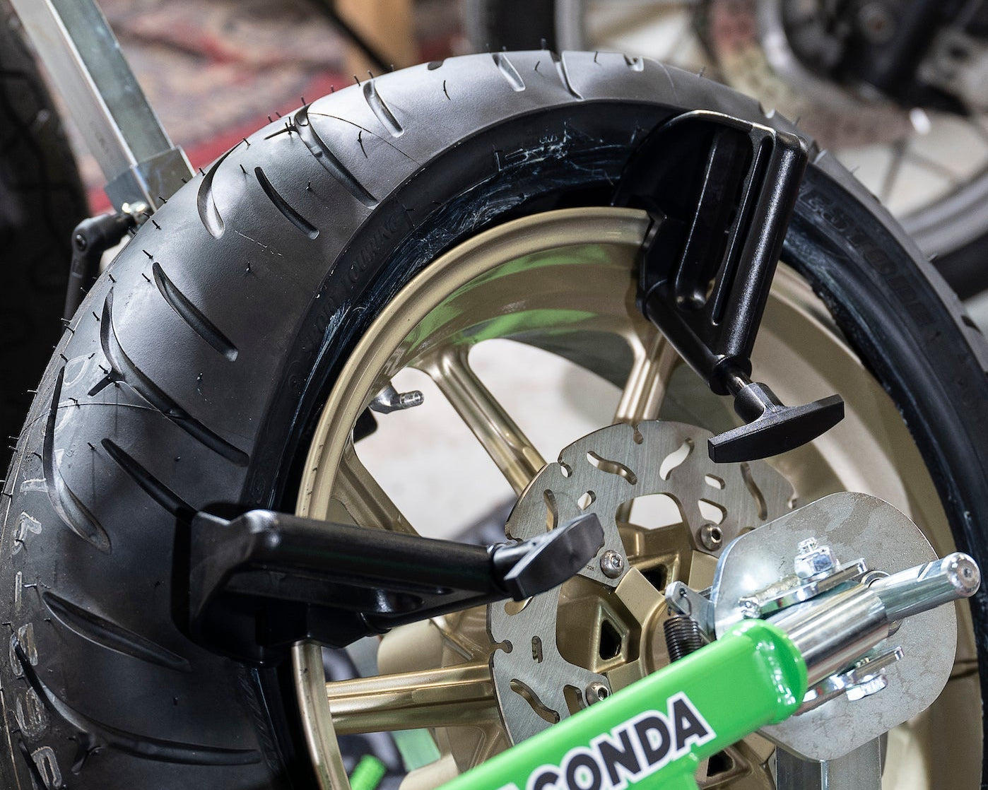 Portable tire changer and tools designed for quick motorcycle tire changes at home or trackside