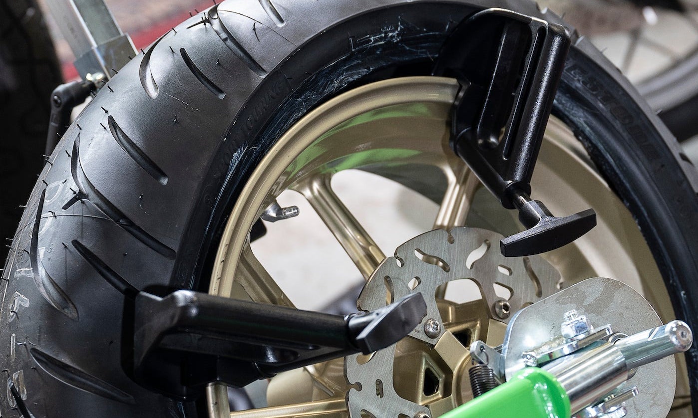 Portable tire changer and tools designed for quick motorcycle tire changes at home or trackside
