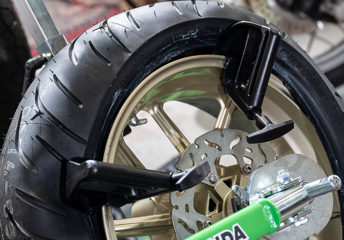 Portable tire changer and tools designed for quick motorcycle tire changes at home or trackside