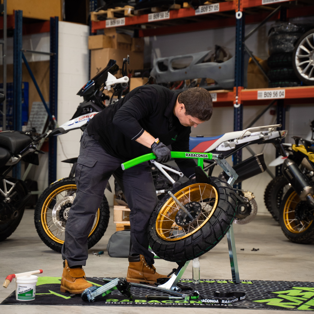 Street motorcycle tire bead breaker pressing down on the tire